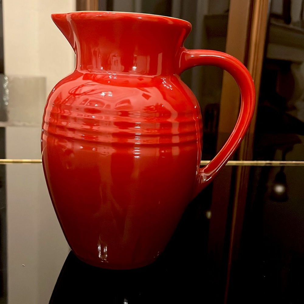 Le Creuset stoneware pitcher in red. Perfect for holidays.Excellent condition.